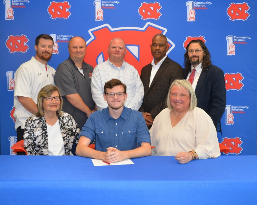 Neshoba Central’s Matt Weir signed with William Carey to further his education and be a member of the band. Pictured, front from left are his grandmother, Geraldine Therrell, Matt Weir, and his mother Stacie Weir (Back) Assistant Principal Jonathan Walker,  Principal Jason Gentry, Assistant Principal Brent Pouncy Assistant Principal LaShon Horne, and Band Director Daniel Wade.